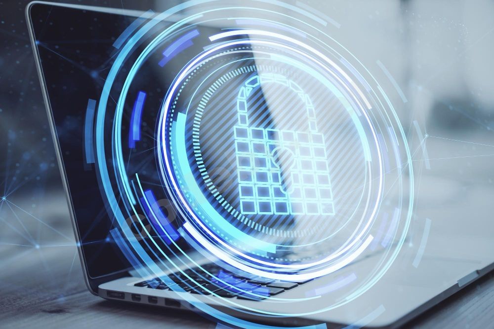 close-up-of-laptop-computer-on-desktop-with-creative-glowing-blue-padlock-hologram-on-blurry-b...jpg