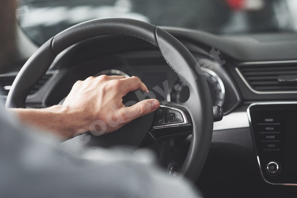 man-s-big-hands-on-a-steering-wheel-while-driving-a-car.jpg