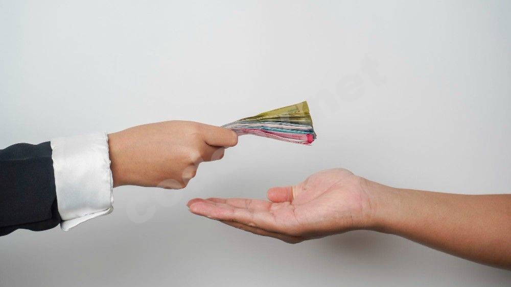 portrait-businessman-giving-money-indonesian-rupiah-business-deal-payment-charity.jpg